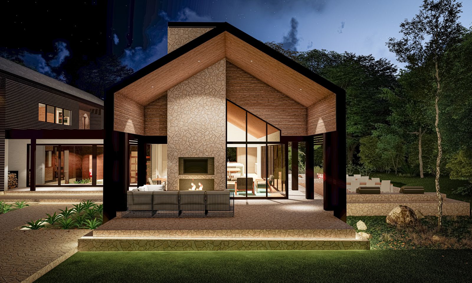 Night view of a cabin-style residence with a stone fireplace under a wood-lined gable