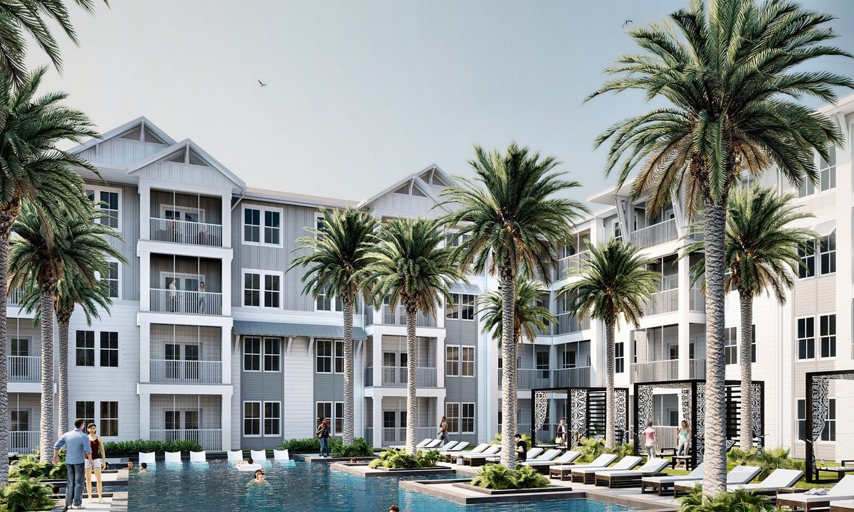 Palm-lined pool courtyard between four-story apartment buildings