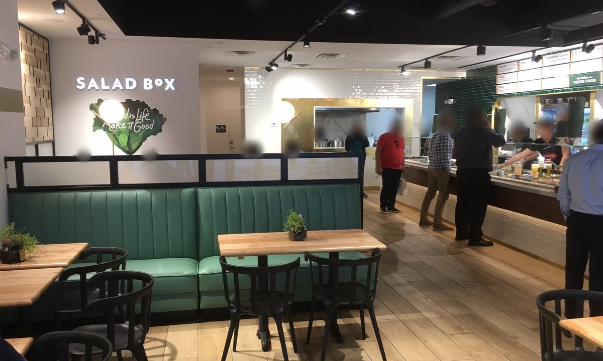 Salad Box dining room with green banquettes and the serving line